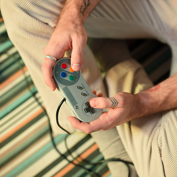 Play video game with game controller at home - whatgeek